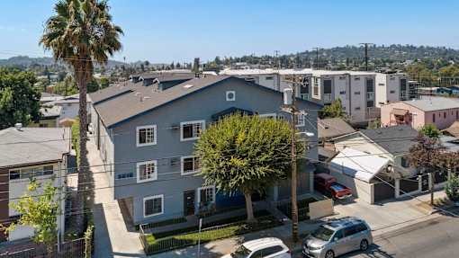 A residential area with houses and parked cars.