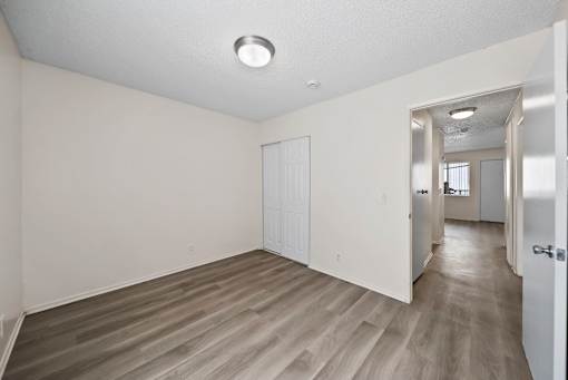 A room with a white door and a white wall.