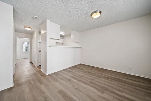 A room with white walls and wooden flooring.