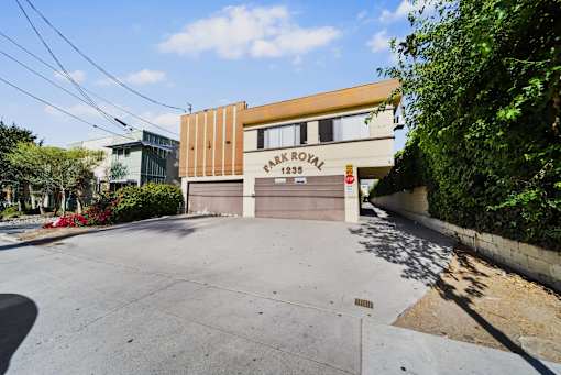 A building with a brown and beige facade has a sign that reads "Fair Royal 1236.".