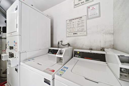 A white washing machine with a control panel on top.