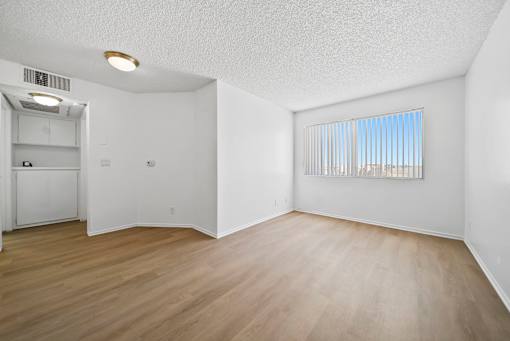 A room with a window and a door.