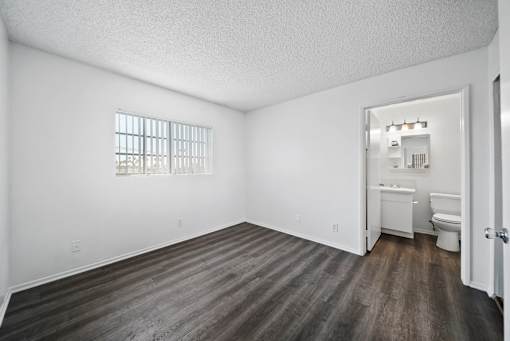 A room with a toilet, sink, and window.