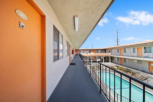 A balcony with a pool and a view of the sky.