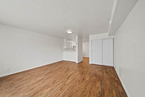 A room with wooden floors and white walls.