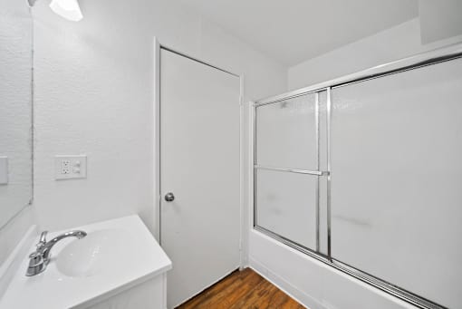 A white sink in a small bathroom.