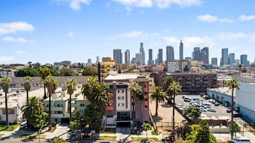 A cityscape with a clear blue sky and buildings in the distance.