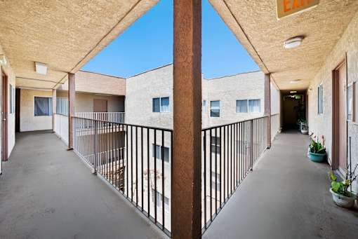 A long hallway with a balcony on the left side.