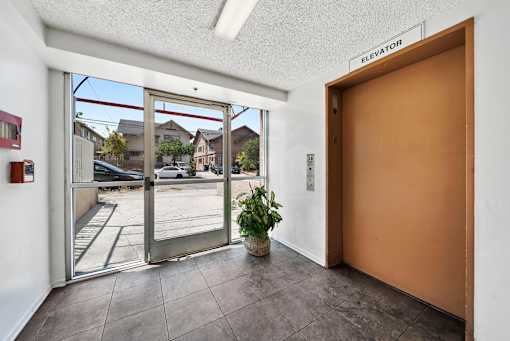 A brown door with a sign above it that says "elevator".