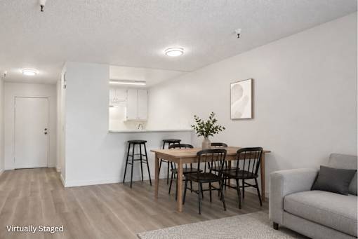 A dining room with a table and chairs.