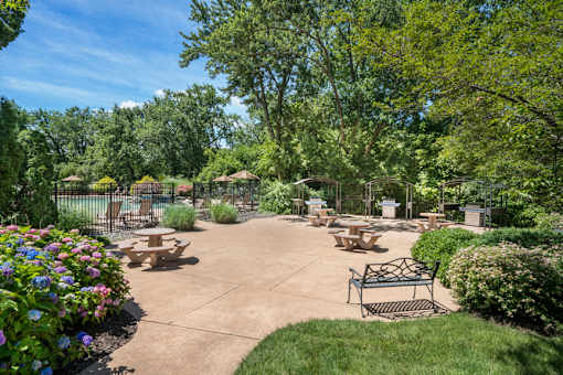 A park with a bench and a flower bed at Rivercrest Apartments, Piscataway  08854
