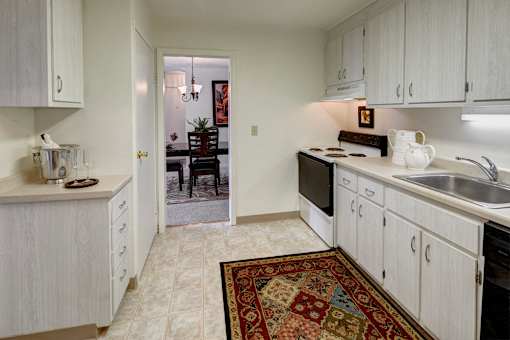 Classic kitchen with large pantry,  electric stove, dishwasher, and fridge at Kings Gate West Apartments, Camillus