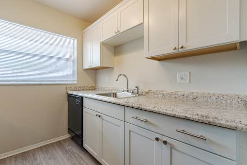 Kitchen with white cabinetry at Imperial Gardens, Clearwater, FL, 33764