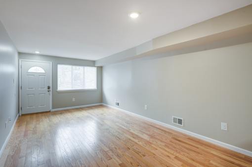 A room with a wooden floor and a white door at Seaview Apartments in Staten Island, NY, 10305