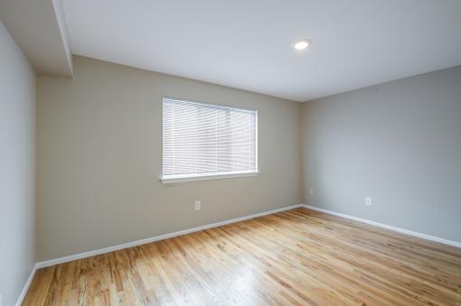 A room with a window and wooden flooring at Seaview Apartments in Staten Island, NY, 10305