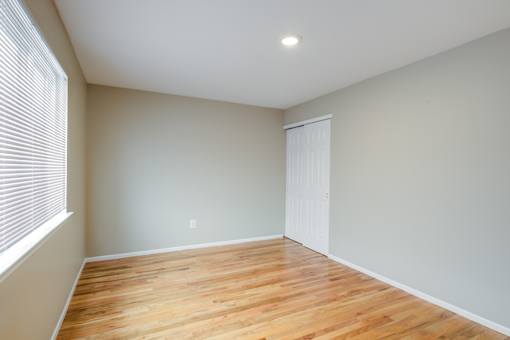 A room with wooden flooring and a white door at Seaview Apartments in Staten Island, NY, 10305