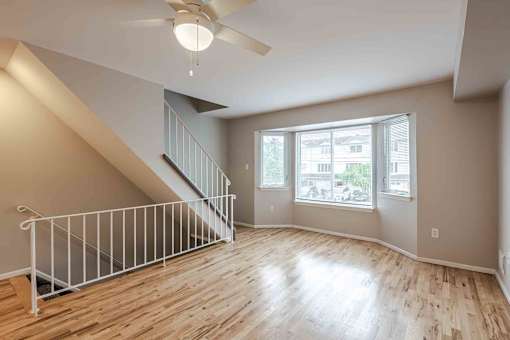 A room with a staircase and a ceiling fan at Seaview Apartments in Staten Island, NY, 10305