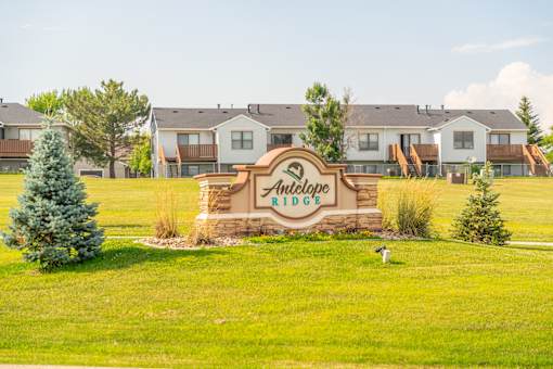 A sign for Antelope Ridge in front of houses.