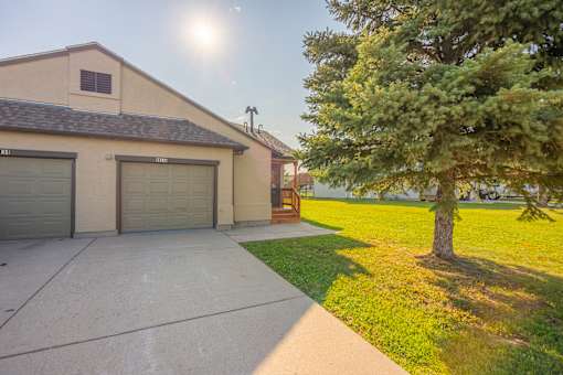 A house with a garage and a tree in front at Antelope Ridge.