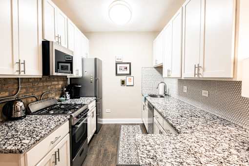 A kitchen with a black and white granite countertop.