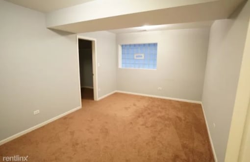 a empty room with a blue and white wall and a carpet