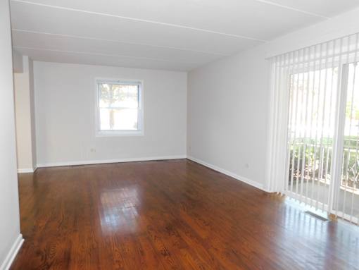 A room with wooden floors and a window.