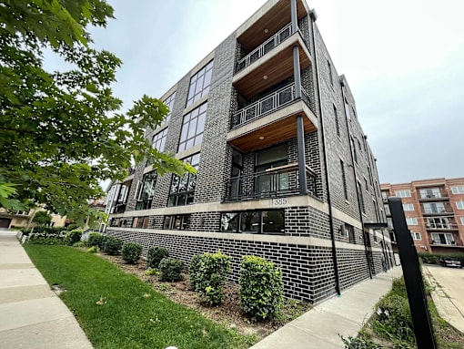 A modern apartment building with balconies and windows.