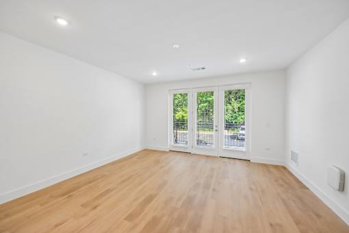 A room with wooden floors and white walls.