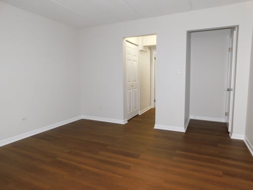 A room with wooden floors and white walls.
