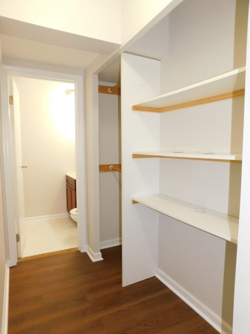 A hallway with a toilet visible in the background.