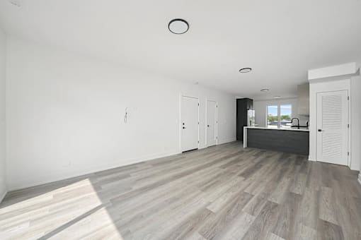 A spacious room with a grey floor and white walls.