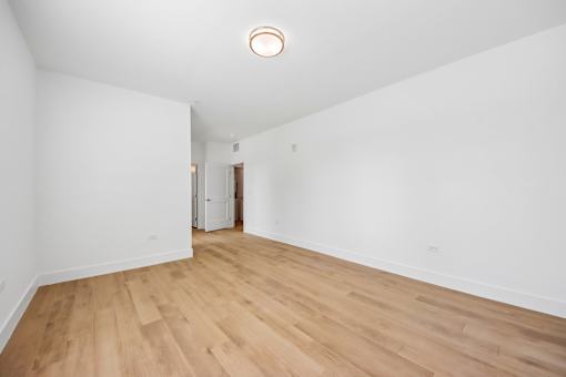 A room with wooden floors and white walls.