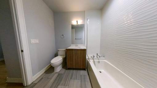 A white bathroom with a toilet, sink, and bathtub.