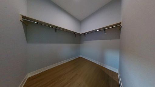 A room with a wooden floor and white walls.