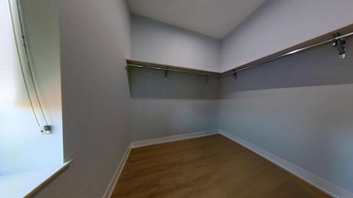 A room with a wooden floor and white walls.