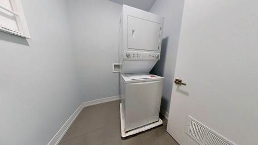 A white tankless water heater in a room.
