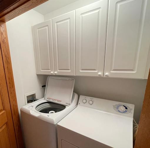 A white washing machine and dryer in a small laundry room.