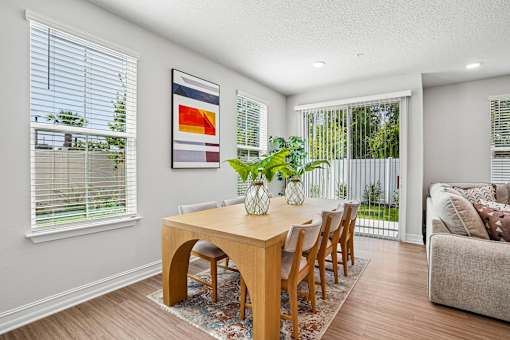 A dining room with a wooden table and chairs.
