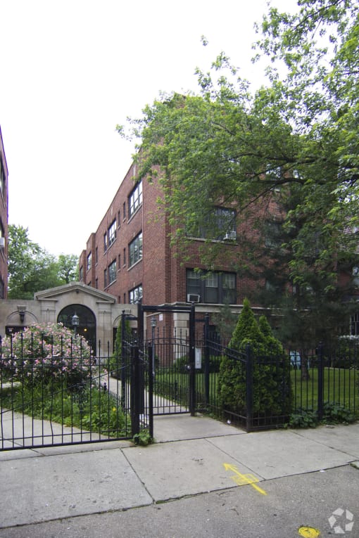 a building with a fence and a gate in front of it