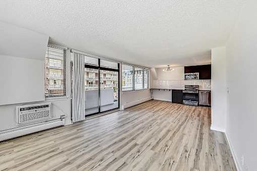 A room with a white wall and a wooden floor.