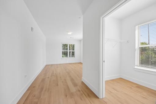 A room with wooden floors and white walls.