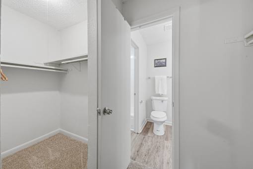 A white bathroom with a toilet and a door.