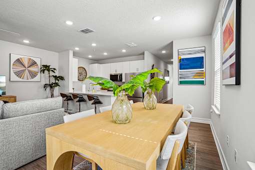 A dining room with a wooden table and chairs.