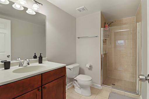 A bathroom with a toilet, sink, and shower.
