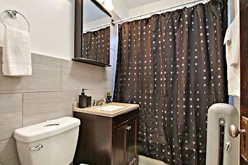 A white toilet sits next to a sink in a bathroom.