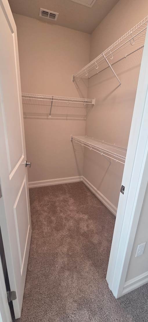 Walk in closet with custom built in shelving