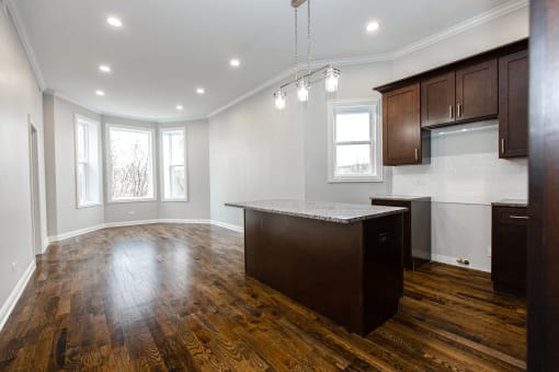an empty kitchen with a large island in the middle