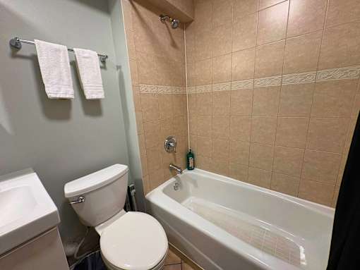 A bathroom with a toilet, sink, and bathtub.