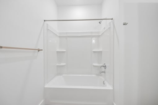 A white bathroom with a tub and shower.