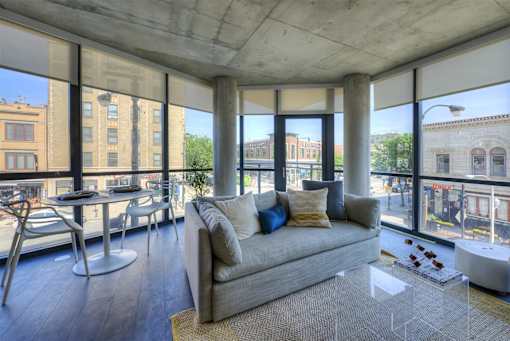 A modern living room with a couch, chairs, and a coffee table.